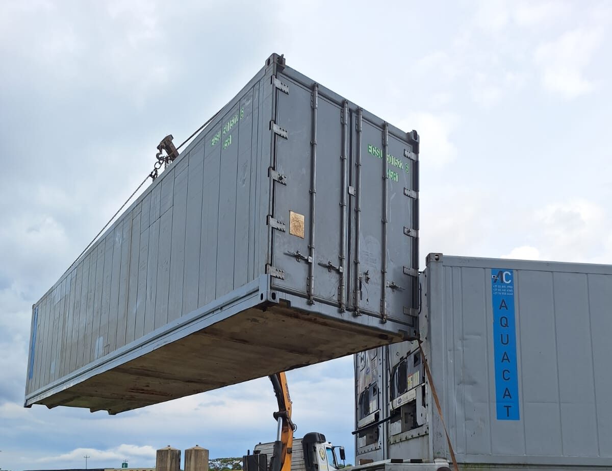 AquaCat refrigerated container being craned into position during an on-site delivery